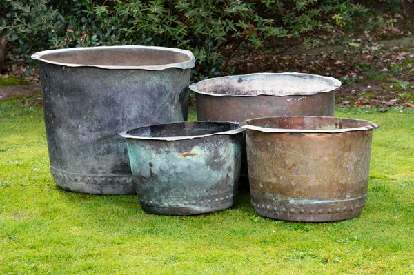 A collection of four washing coppers 19th century of riveted construction the largest 57cm high by 70cm diameter