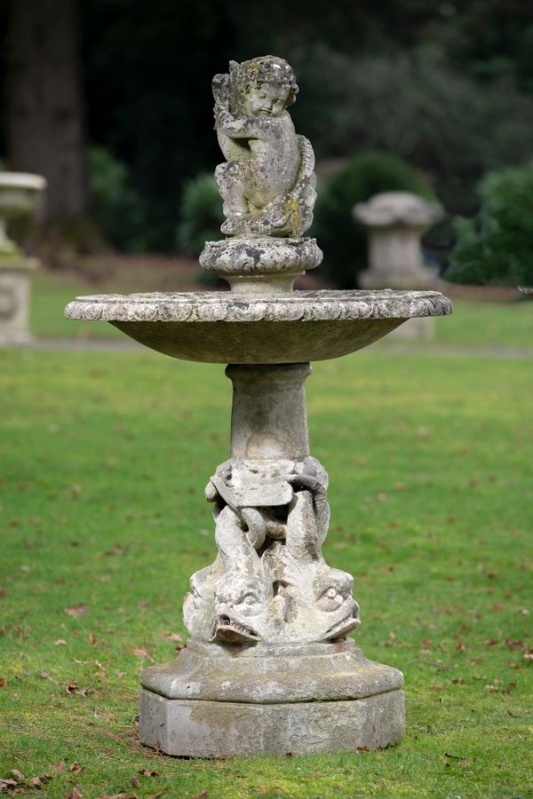 A carved limestone fountain 2nd half 20th century the top fish and dolphins drilled for water 160cm high, bowl diameter 92cm  GE082 Unsold lot fee...