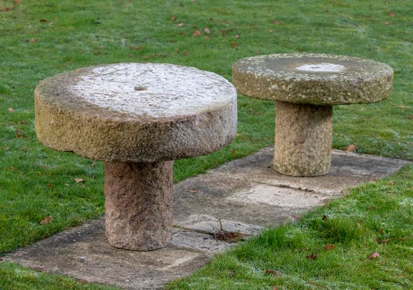 Two carved granite occasional tables  made up incorporating millstones 60cm and 67cm diameter 