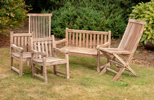 A suite of child‘s hardwood furniture 2nd half 20th century comprising seat, 90cm long and two chairs, together with a pair of folding deck chairs