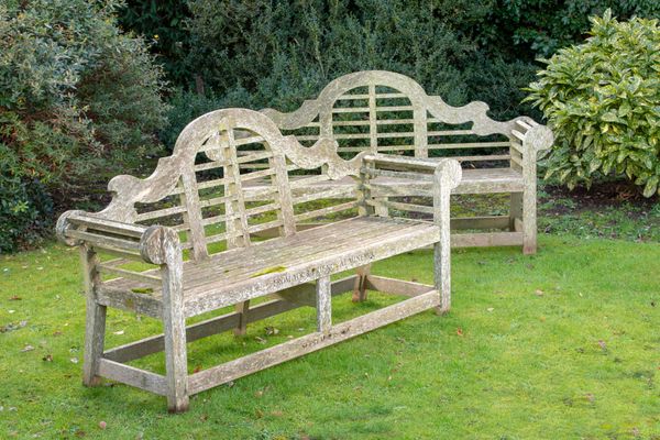 A pair of hardwood Lutyens seats with maker‘s plaque and presentation inscription dated 2005 196cm long 