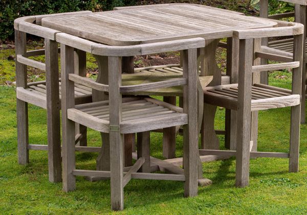 A suite of teak ship breakers furniture  2nd half 20th century  comprising table and four corner chairs, bearing makers plaque Made by Hughes Bolckow...