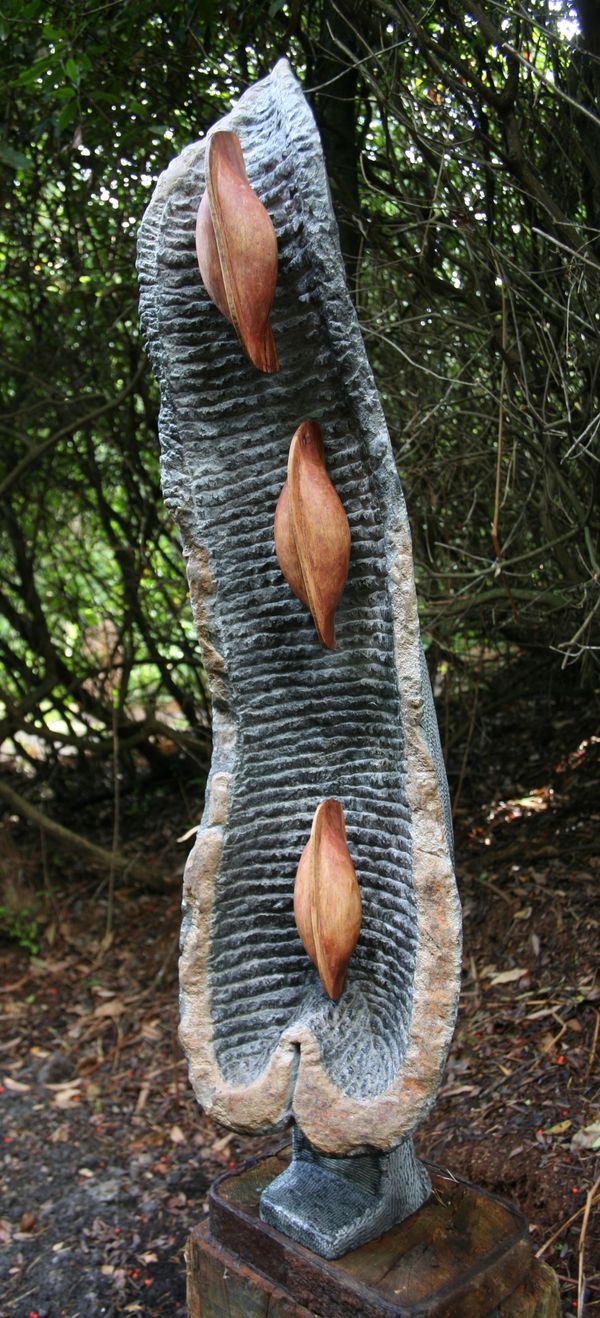 Albert Wachi, Born 1963 Seed pod Springstone and cedar Signed Unique 127cm high