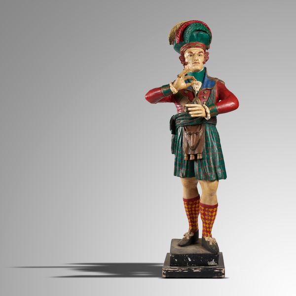 A polychrome painted wood tobacconist‘s figure of a Scotsman holding a snuff mull 2nd half 20th century 210cm high Provenance: Being sold by the...