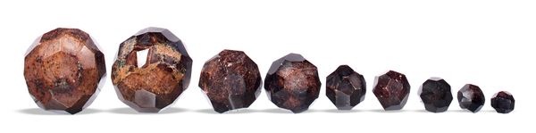 A collection of 9 garnet polyhedrons Mysore, India the largest 12cm