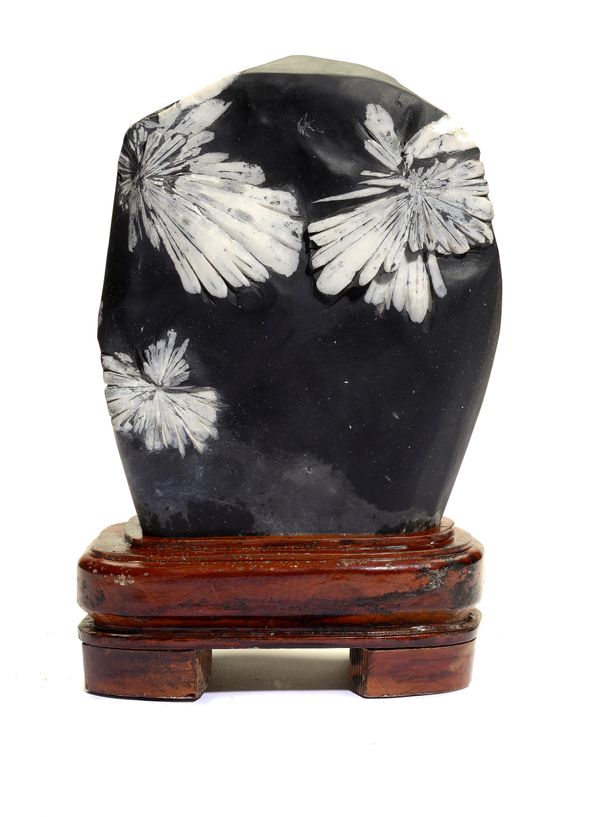 A Chrysanthemum stone on wooden base 35cm overall