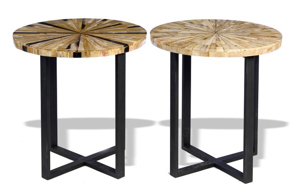 A pair of circular topped occasional tables the top veneered in Indonesian fossilised wood 51cm diameter