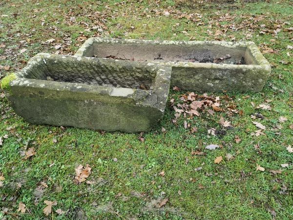 A rectangular carved stone trough 9cm high by 130cm wide by 38cm deep, and another carved stone trough, 23cm high by 73cm wide by 34cm deep From the...