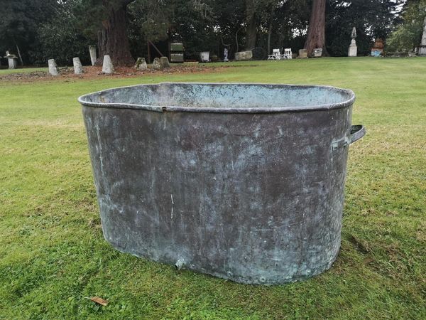A rounded rectangular copper vat 19th century with tap hole 60cm high by 113cm wide From the personal collection of Tim Wonnacott.  See lot 400 for...