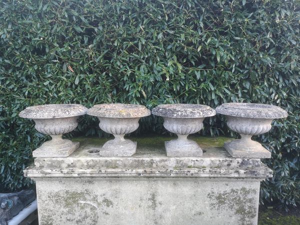 A set of four composition stone tazza urns 2nd half 20th century 50cm diameter From the personal collection of Tim Wonnacott.  See lot 400 for...