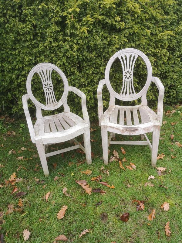 A near pair of Anglo-Indian teak Hepplewhite style armchairs 2nd half 20th century From the personal collection of Tim Wonnacott.  See lot 400 for...