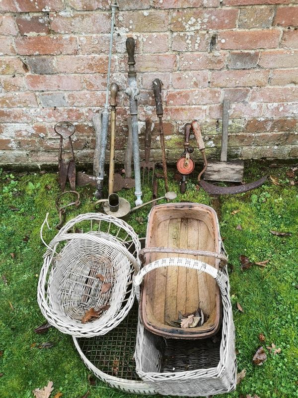 A collection of vintage garden tools including three brass rose sprays, shears, axes, hand drill, Hawes brass watering can, sieve, two baskets and a...