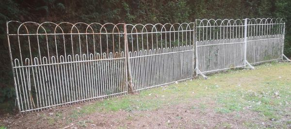 A run of 7.3 metres of wrought iron estate railing 19th century comprising four panels including two on castors and two on bracket bases 118cm...