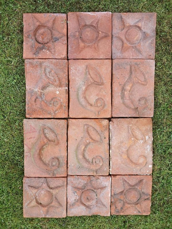 A collection of twelve Arts and Crafts terracotta wall plaques mid 19th century together with stainless steel wall fittings the rectangular ones 20cm...