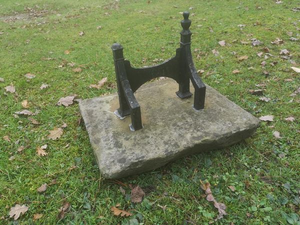A wrought iron boot scraper on sandstone base mid 19th century 44cm wide From the personal collection of Tim Wonnacott.  See lot 400 for further...