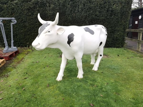 A resin ‘Cow Parade‘ Friesian cow  circa 2000 145cm high by 235cm long Presented by Ester Rantzen on behalf of Childline to Tim Wonnacott Chairman...