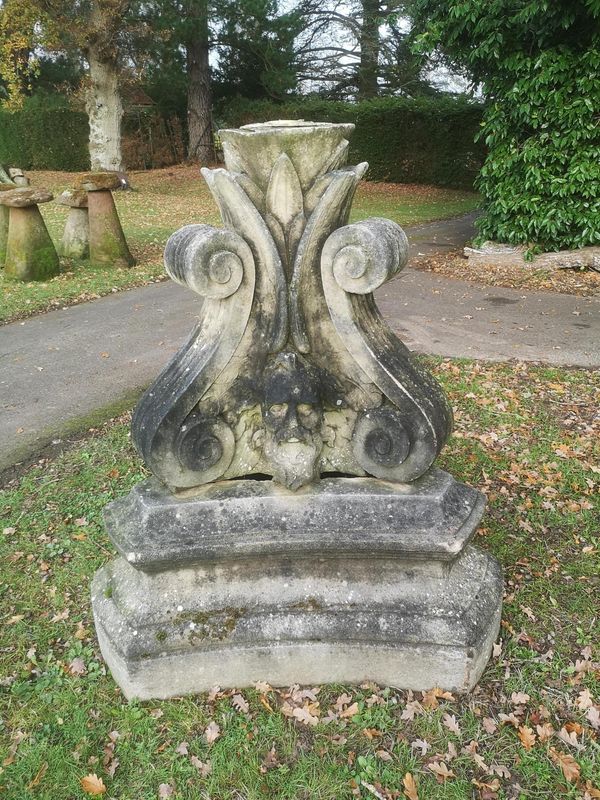 A composition stone triangular fountain base 2nd half 20th century 128cm high From the personal collection of Tim Wonnacott.  See lot 400 for...