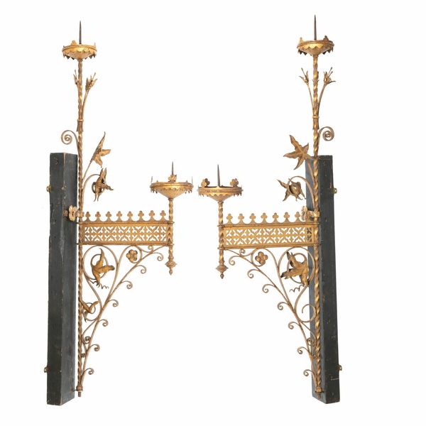 A pair of painted wrought iron Gothic wall scones French, circa 1860 with hinged wall bracket 130cm high by 50cm deep 