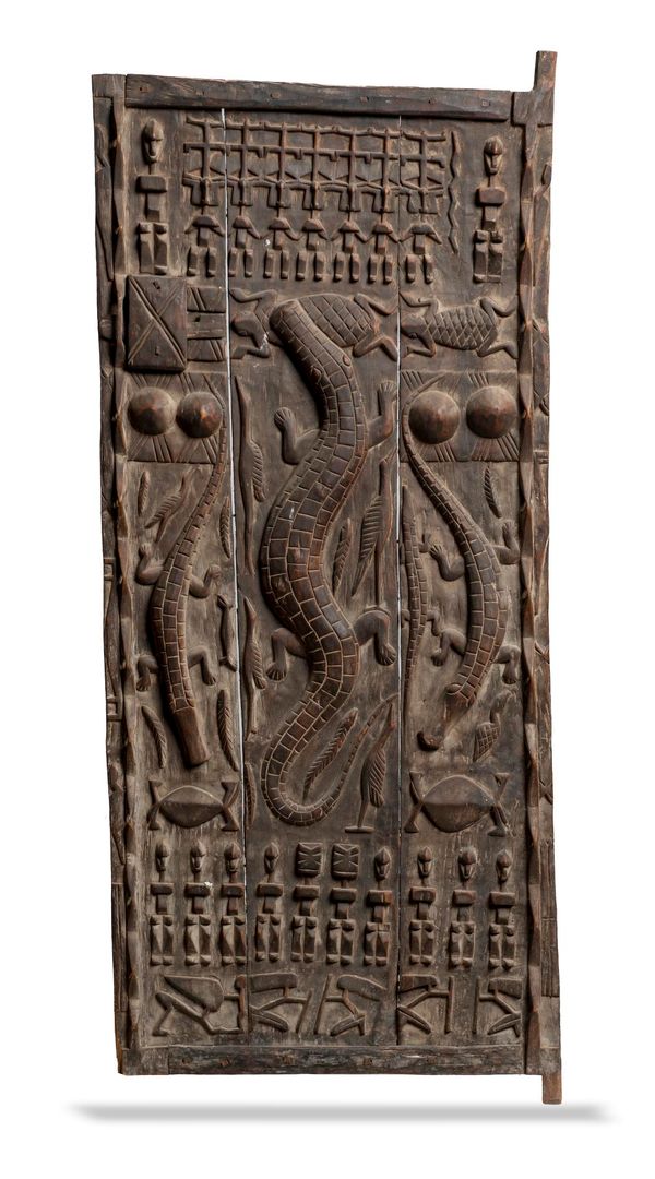 A pair of carved hardwood West African tribal doors early 20th century  each 176cm by 80cm wide  