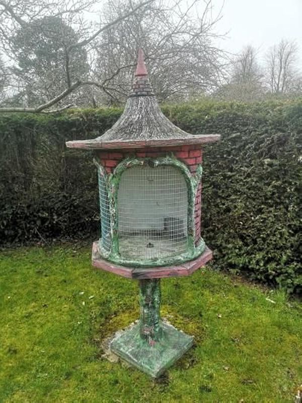 A painted composition stone bird cage