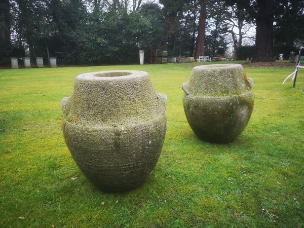 † A pair of carved sandstone lug pots