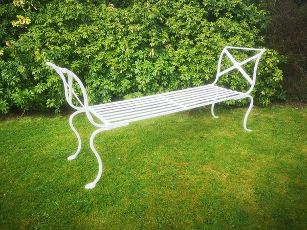 A Regency style wrought iron bench made-up and incorporating some early elements 188cm long