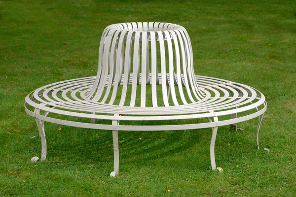 A strapwork iron tree seat  modern 182cm diameter