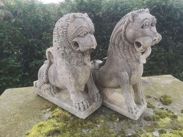 † A near pair of sandstone mythological lions