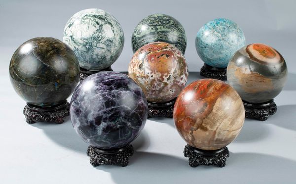 A set of 8 mineral specimen spheres  including Labradorite 16.3cm, Fluorite 15.2cm, polychrome jasper 14.5cm, Apatite 14.6cm and Kambaba jasper...