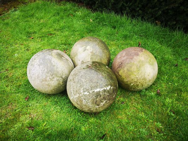 A set of four carved stone balls 35cm diameter