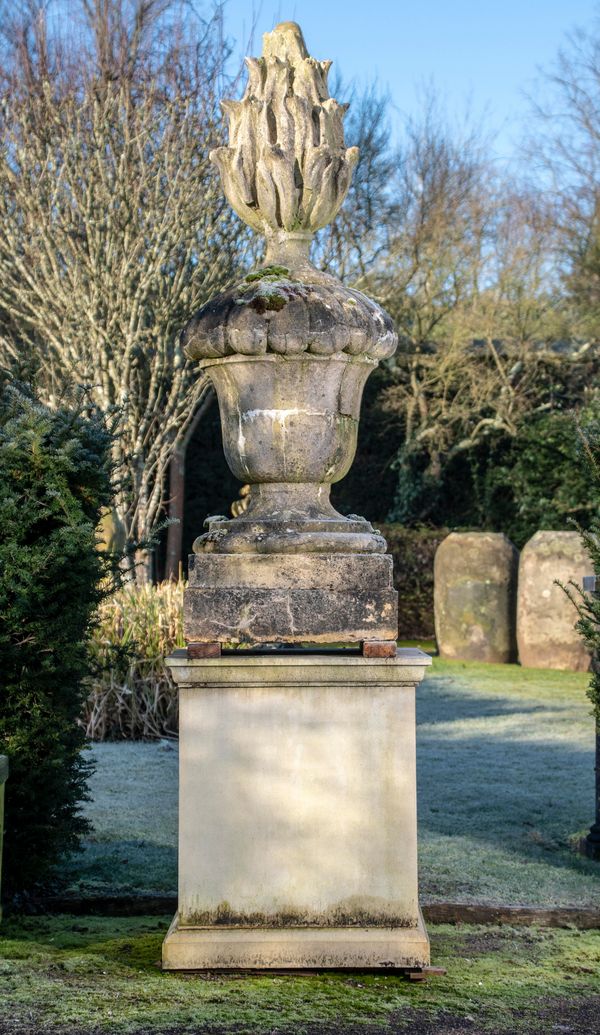 A substantial Victorian composition stone finial 2nd half 19th century on later composition stone plinth the finial 200cm; 290cm overall