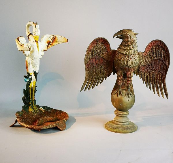 A cast iron stick stand 20th century 55cm high, together with a bronze eagle finial, 20th century, 52cm high