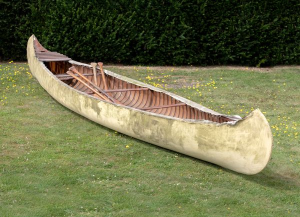 An early and rare Old Town wood and canvas canoe circa 1913 with two pairs of paddles and makers plaque Decal and with stamped number 27389 length...