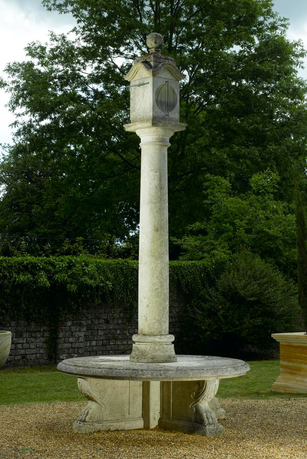 A carved limestone pillar sundial with seat modern with bronze gnomens 315cm high by 150cm diameter