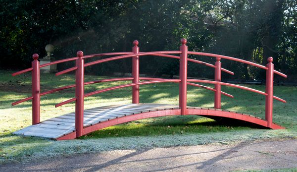 † A wrought iron bridge with wooden slats 492cm long by 156cm wide