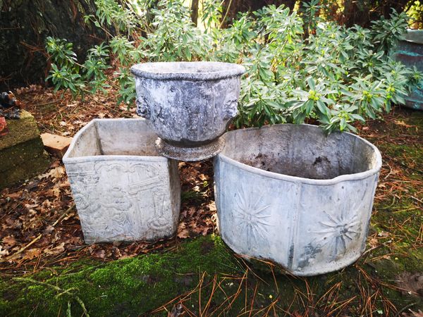 Three lead planters early 20th century  the largest 30cm high by 50cm diameter