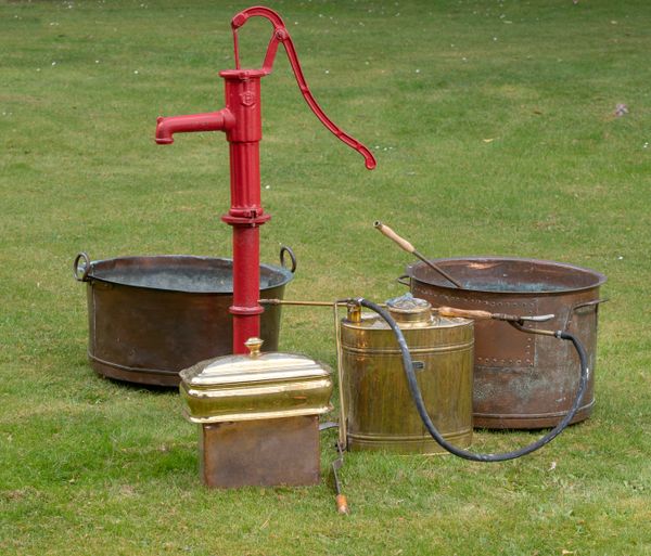 Two washing coppers with handles 19th century the larger 64cm diameter, together with a cast iron pump, a brass garden sprayer and a copper and brass...
