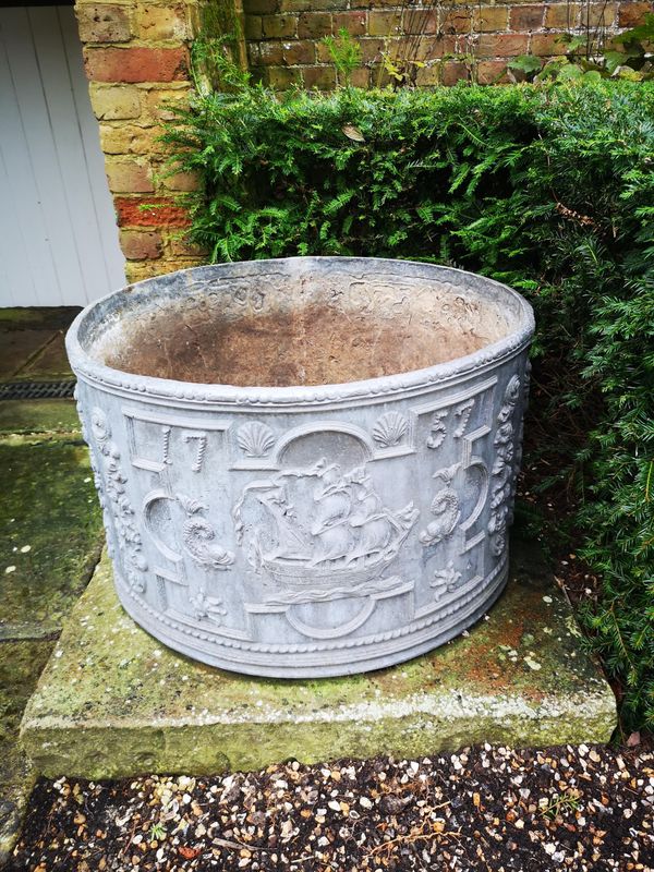 A Georgian style circular cistern planter bearing the date 1757 49cm high by 73cm diameter