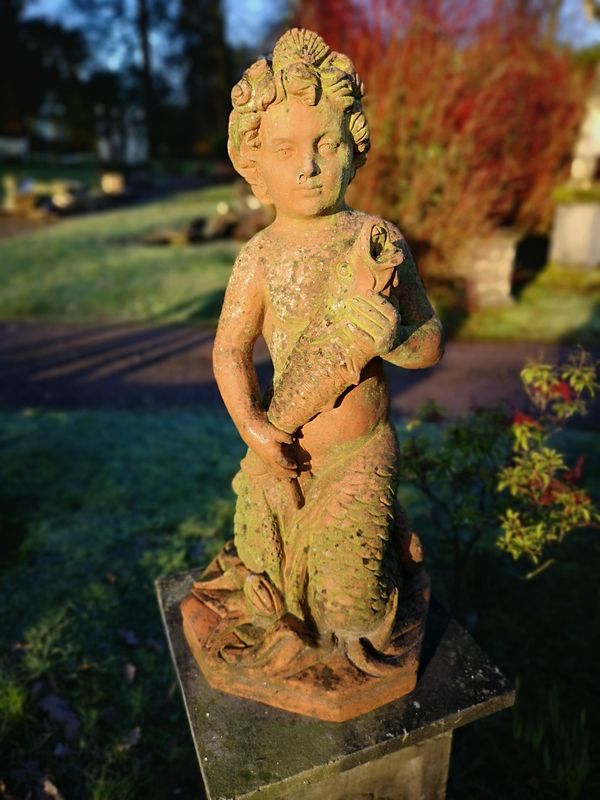 A terracotta fountain figure of a mer-child Italian, early 20th century drilled for water 80cm high