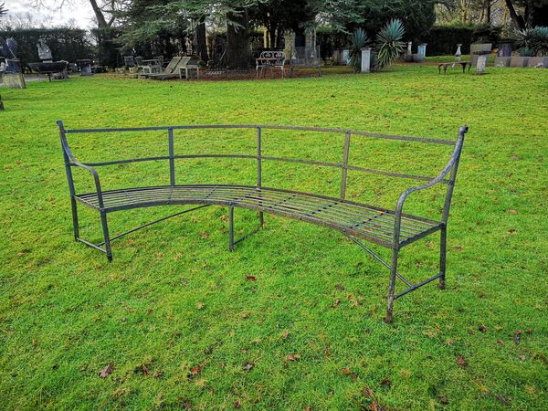 A strapwork curved iron seat late 19th century 240cm long