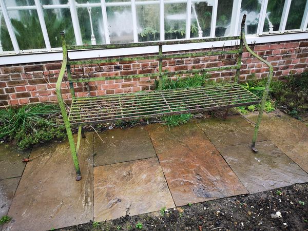 A Regency reeded wrought iron seat faults and old repairs 167cm wide