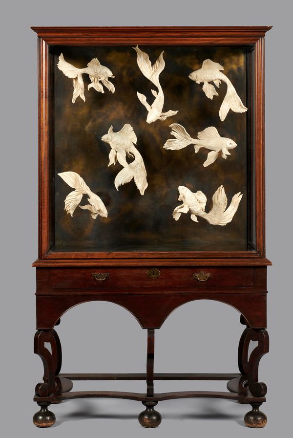 &#9650; April Young: Glazed pottery Siamese fighting fish in early 18th century walnut chest on stand 183cm high by 110cm wide by 61cm deep April...