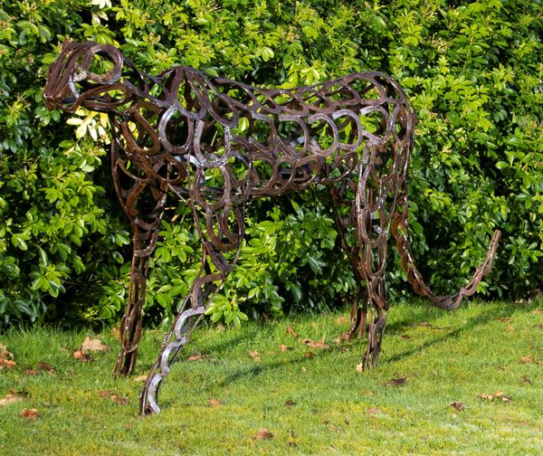 An iron cheetah constructed from simulated horseshoes modern 230cm long by 104cm high