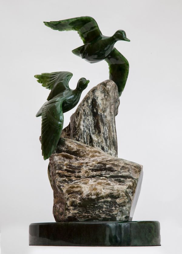 Lyle Sopel (Canadian b 1952)  Carving of two ducks flying Green nephrite on stone base Signed Sopel F033 Unique 44cm high by 34cm wide by 22cm deep