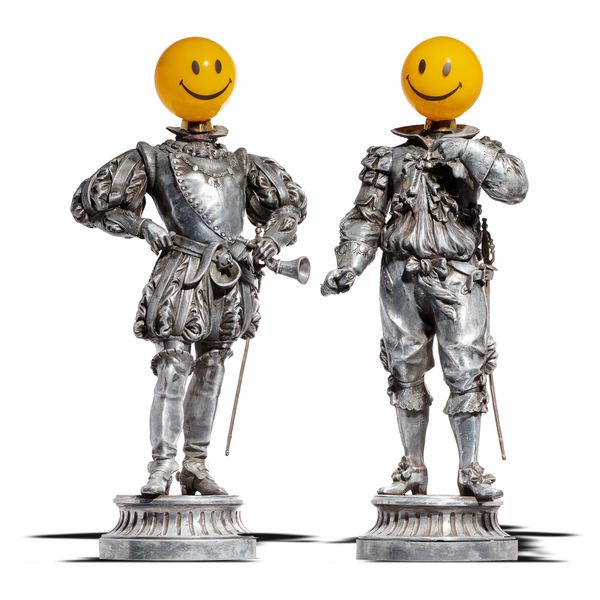 A pair of silvered metal cavaliers in 17th century dress late 19th century with replaced glass globe heads 62cm high