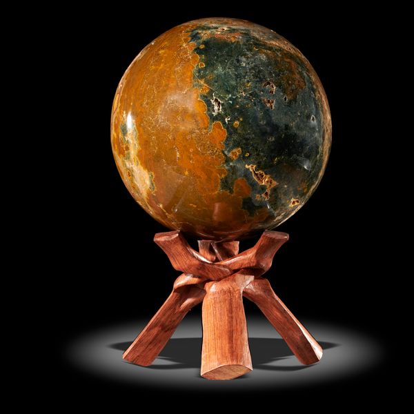 A jasper sphere Madagascar on wooden stand 21cm diameter