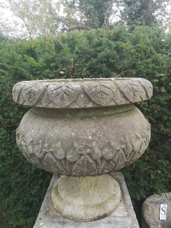 A composition stone urn 68cm high by 66cm diameter