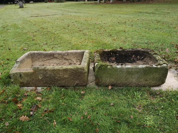 A carved rectangular trough 20cm high by 56cm wide by 40cm deep, and another carved stone trough, 20cm high by 65cm wide by 39cm deep
