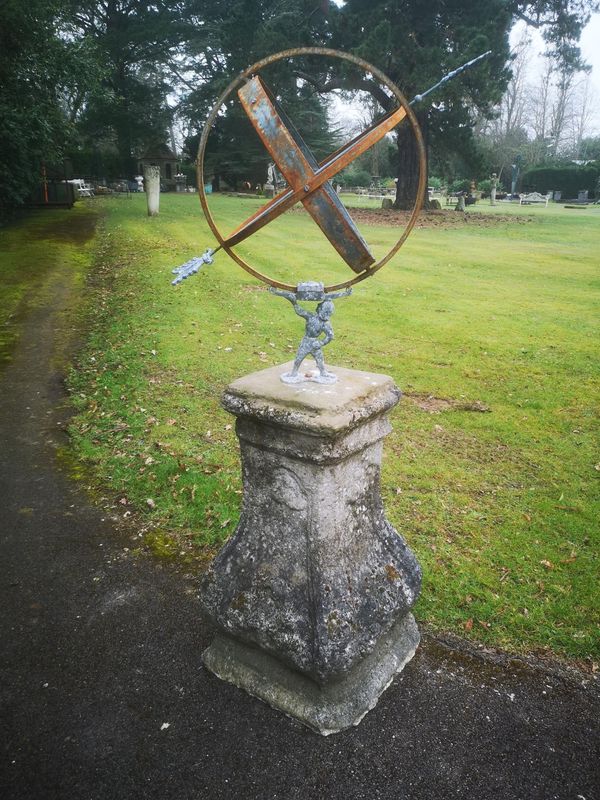 A wrought iron and zinc armillary on Louis XVth style composition stone base late 19th/early 20th century 160cm high