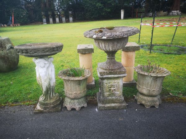 A collection of composition stone 2nd half 20th century including a pair of planters, an urn on pedestal, a pair of pedestals and a bird bath the urn...